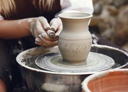 Hands in clay. Pottery theme. On a pottery's machine