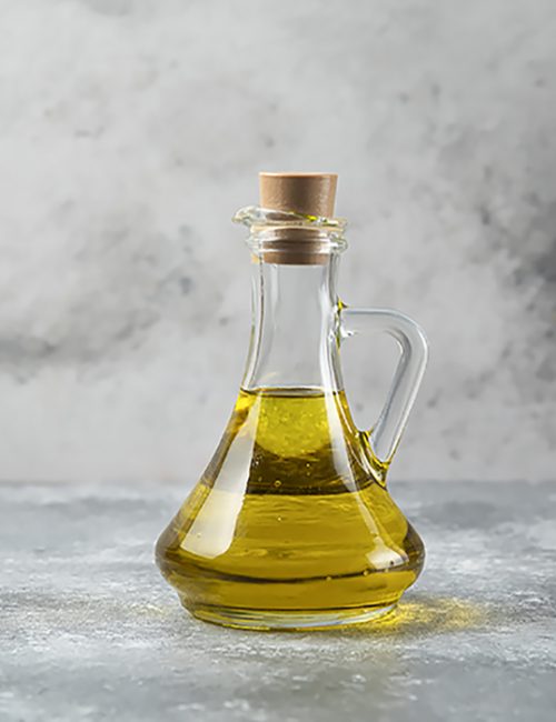 Olive oil bottle on marble table Olive oil bottle on marble table. High quality photo